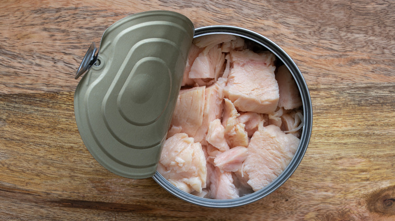 Half-open can of chunk white meat chicken