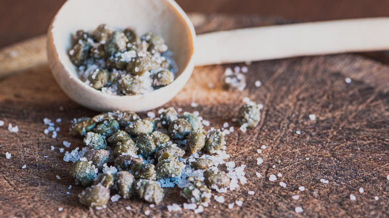 Salt-packed capers on cutting board