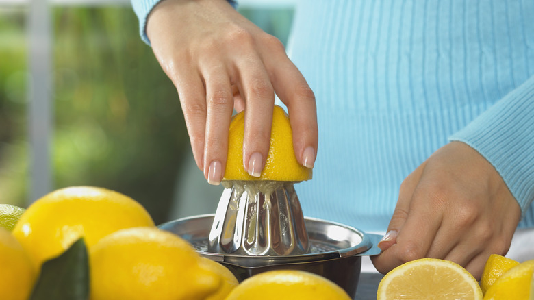 person juicing lemons