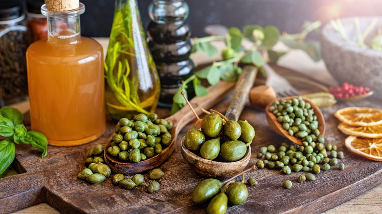 capers and caperberries wooden board