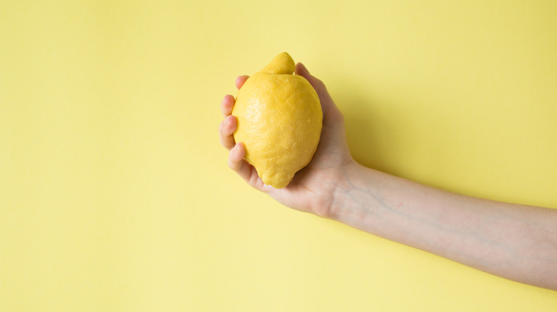 hand holding lemon