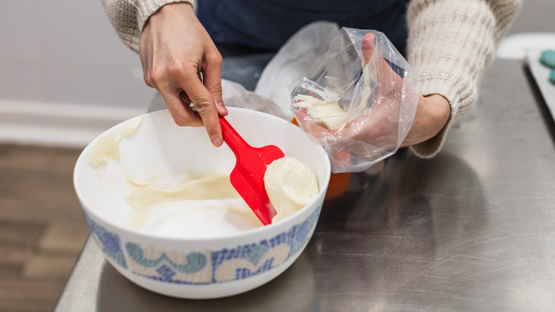 filling piping bag with frosting