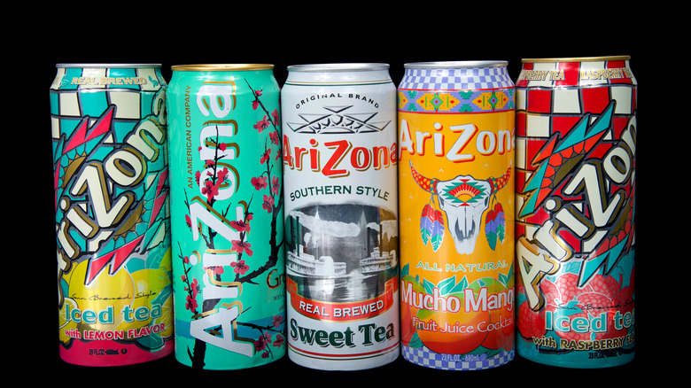 Cans of Arizona brand ice teas in various flavors isolated on black