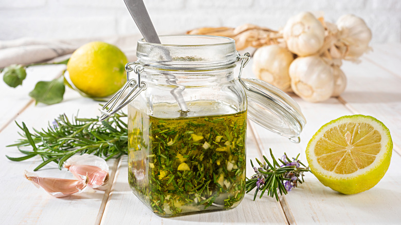 Herby salad dressing with rosemary, lemons, and bulbs of garlic