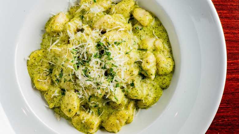 Parmesan grated over gnocchi