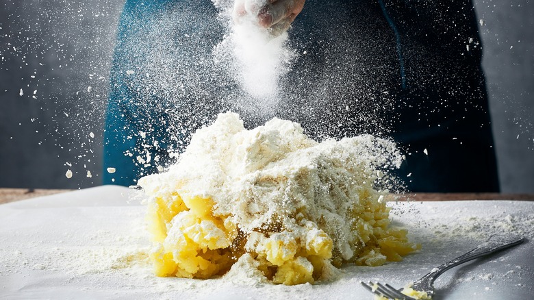 person preparing gnocchi dough