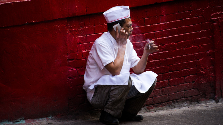 chef squats for cigarette break 