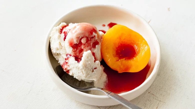 Peach in bowl with ice cream