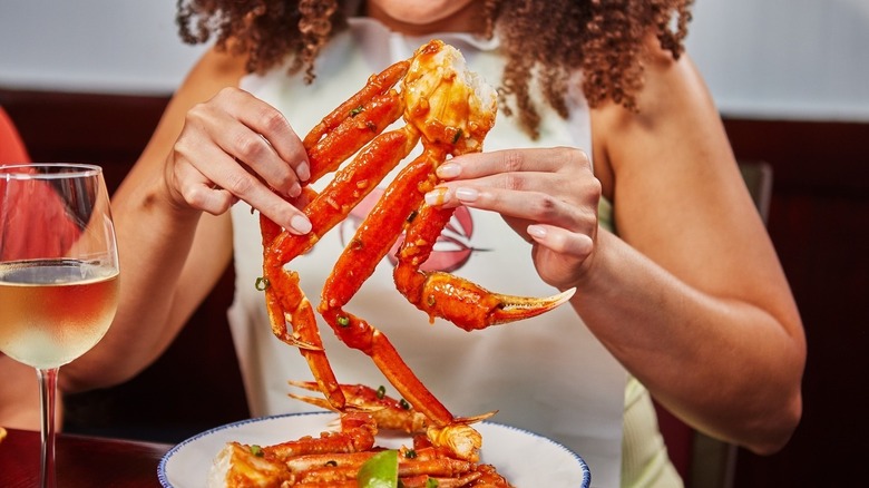 Person eating crab legs at Red Lobster