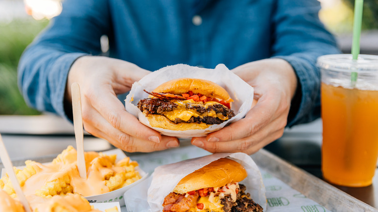 person eating fast food burger