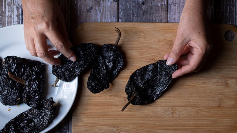 person cooking with dried chiles