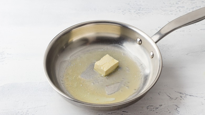 butter being warmed on pan