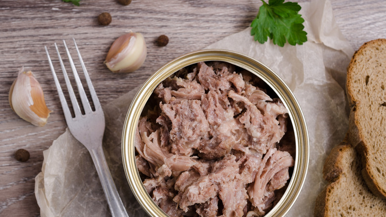 canned chicken with fork on table