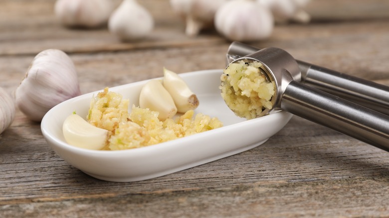 mincing garlic into bowl