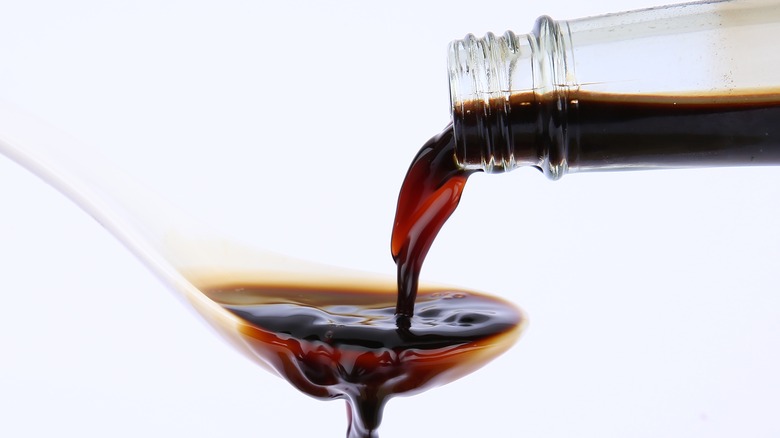 pouring soy sauce onto spoon