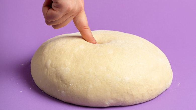 finger poking dough ball