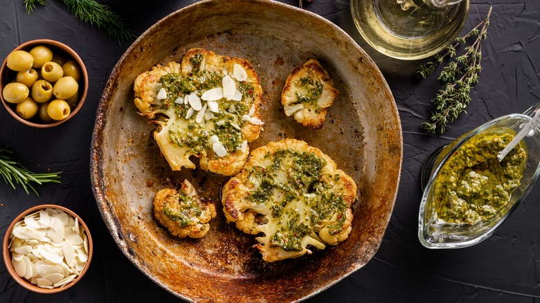 cauliflower steaks with chimichurri and flaked almonds