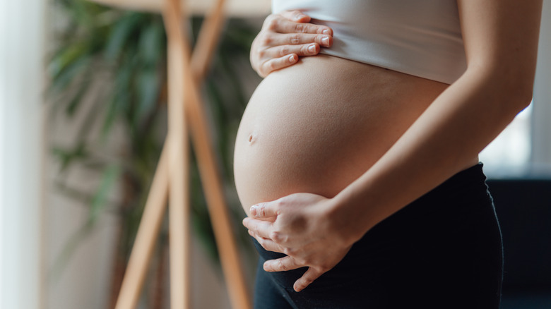 pregnant woman holding belly