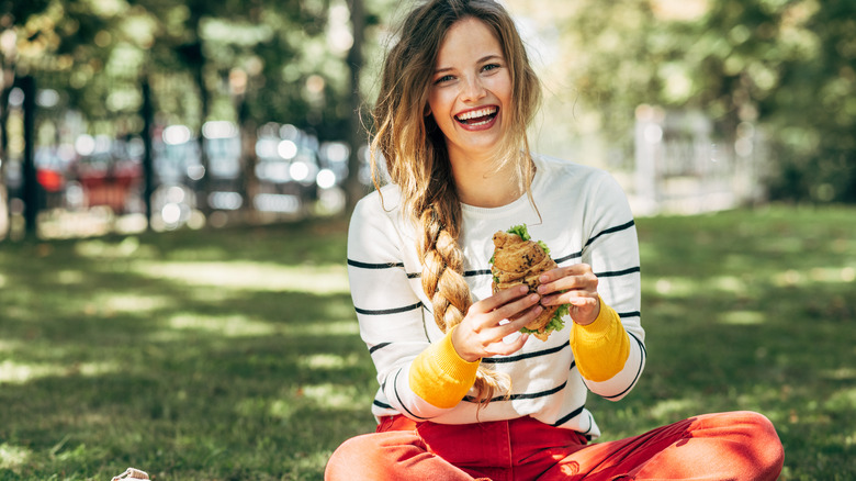 girl on picnic with sandwich