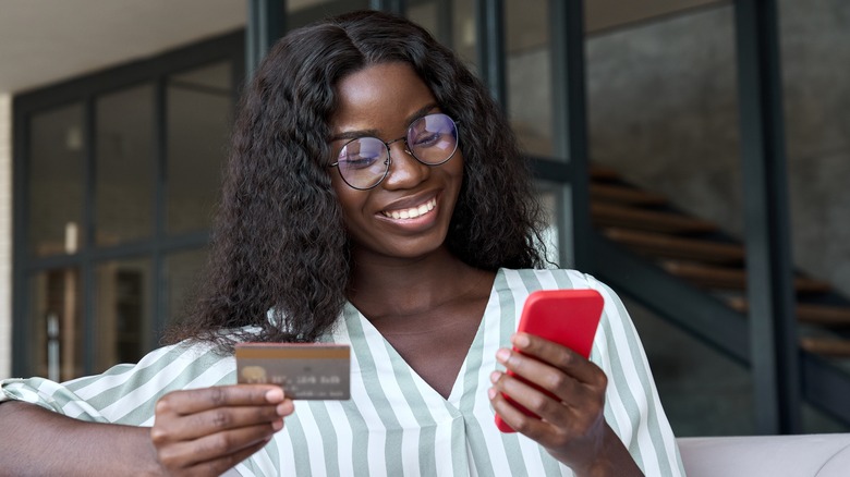 lady using phone and credit card