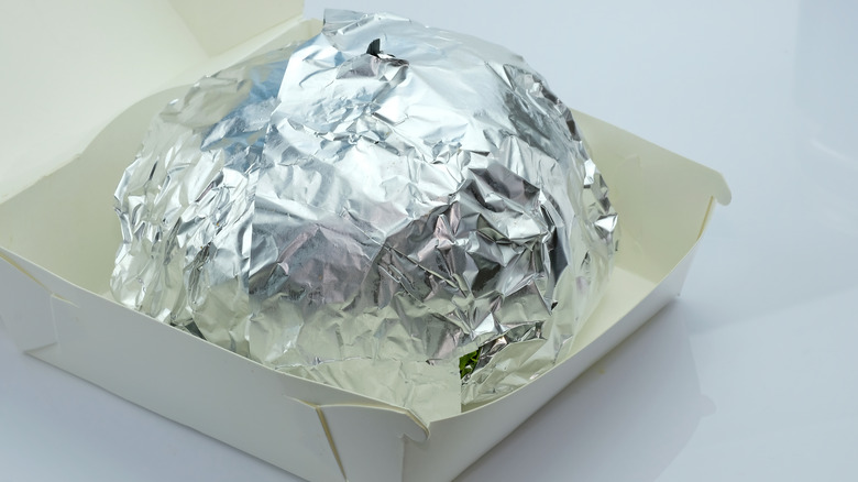 burger wrapped in foil in a box