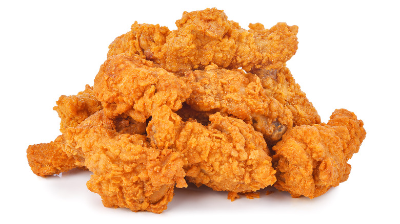 a pile of fried chicken on a white background