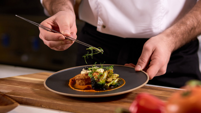 Chef preparing plate of food