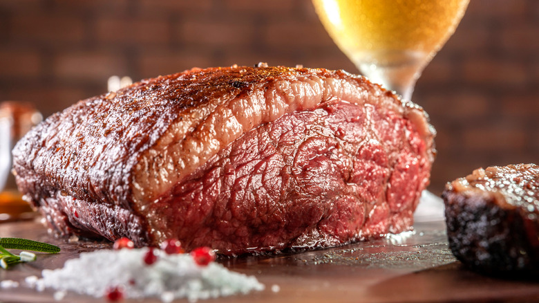 A thick, juicy steak with a beer.