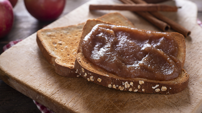 Apple butter on toast with cinnamon sticks