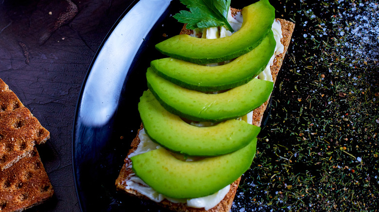 Sliced avocado on board