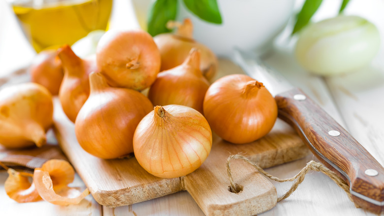 yellow onions on cutting board