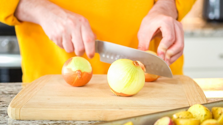 slicing onions on cutting board