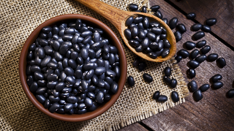 black beans in bowl and on wooden spoon