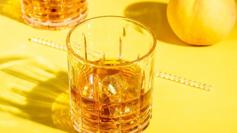 glass and fruit on yellow surface