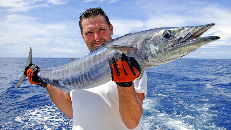 Man holding wahoo fish