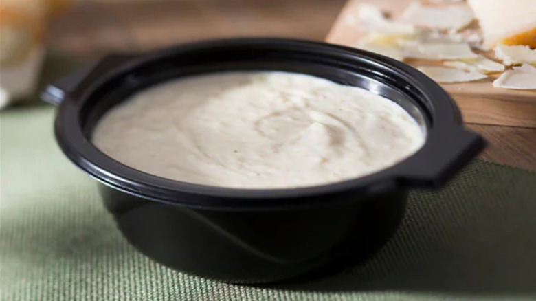 container of alfredo sauce