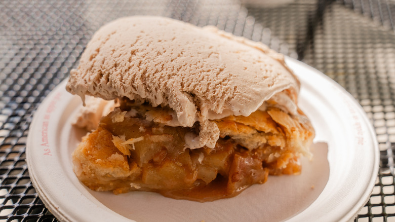 Slice of apple pie topped with ice cream