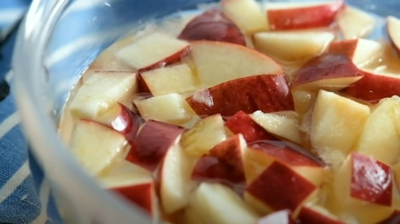 diced apple in bowl of lemon water