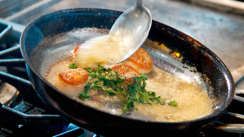 basting scallops in a pan