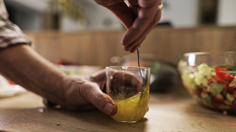 person mixing their own vinaigrette