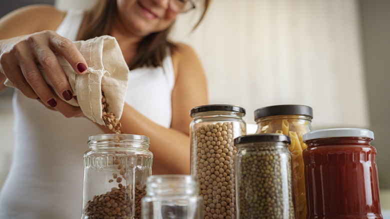 woman storing diverse dried beans