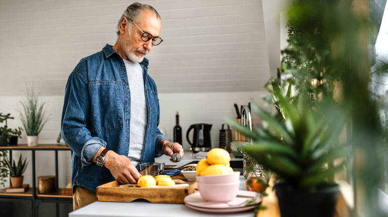 man cooking with lemons