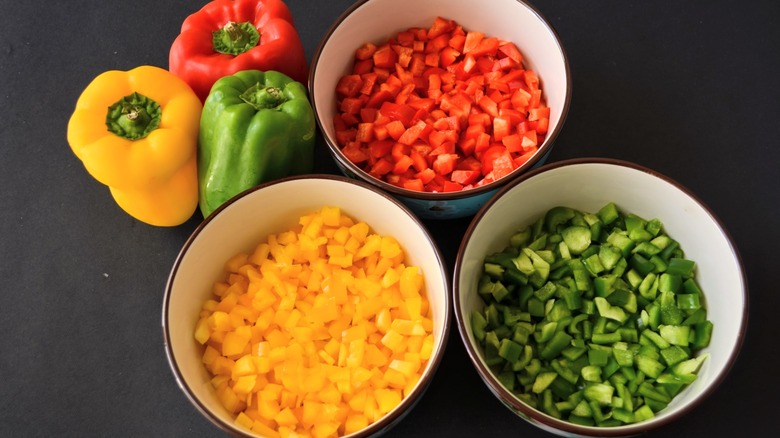 colorful diced bell peppers in bowls