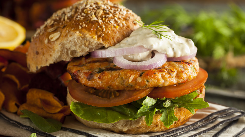 salmon burger with salad and tartar sauce