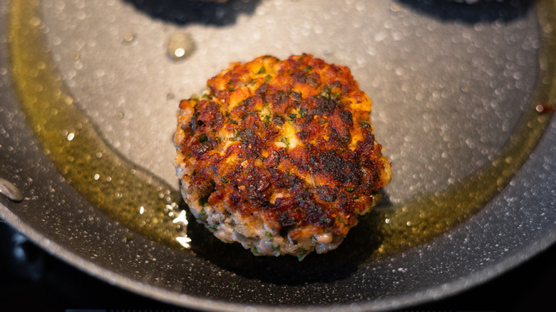 salmon patty in frying pan