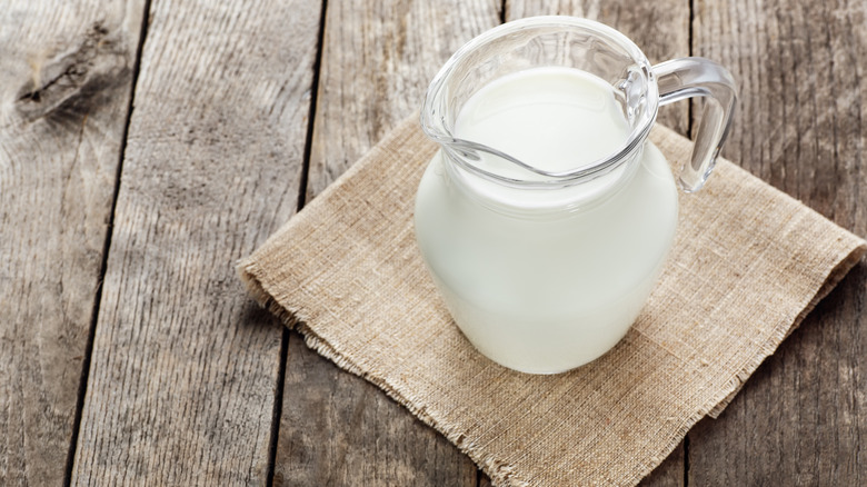 pitcher of cream on wooden table