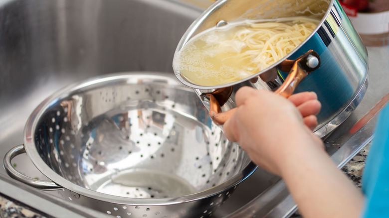 pasta being dumped into colander