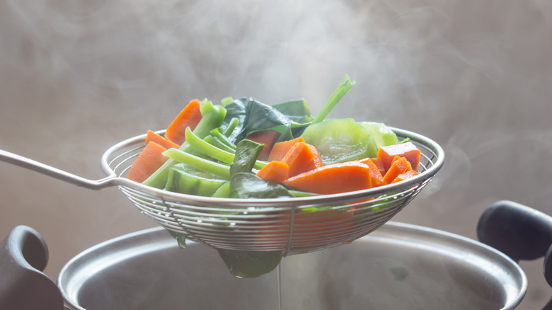 steaming veggies in a colander