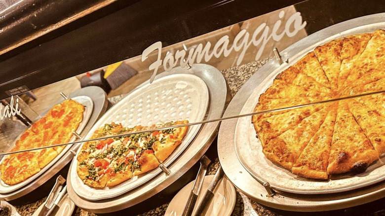 Pizzas on a buffet table at Cinzzetti's