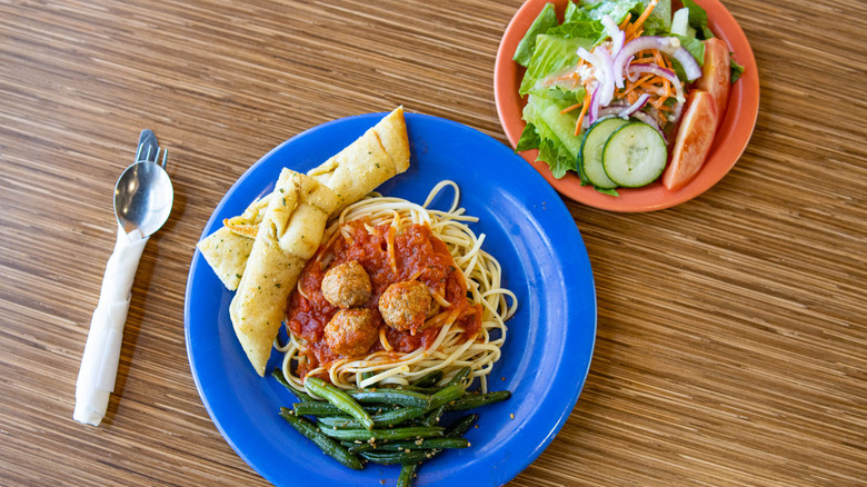 Overhead view of pasta and salad plates